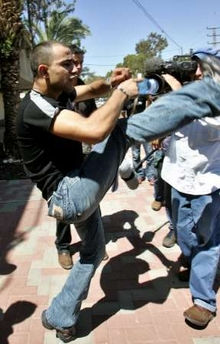 Taysir Hayb attacks reporters outside a military court at Camp Bar-Lev at Kiryat Malachi June 27, 2005. REUTERS/Gil Cohen Magen